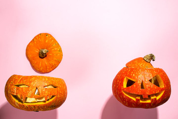 Halloween pumpkin head jack lantern with burning candles isolated on orange, flat lay with copy space