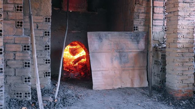 close up of the kiln firing with wood to bake the bricks ( Brick factory)