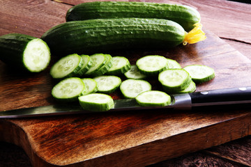 Fresh and sliced cucumbers. Sliced cucumbers on a cutting board. cucumbers for diet and healthy eating
