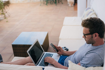 Man working from home at the yard on his computer