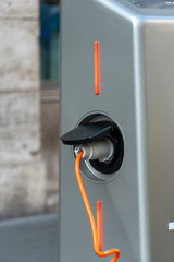 Detail of electric vehicle being charged at station