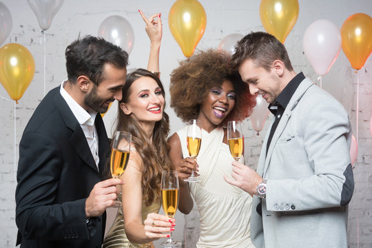 Group of party people celebrating with drinks a birthday or New years eve party
