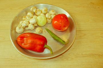 a kitchen concept cooking, culinary, healthy lifestyle. Mushrooms, onion, tomatoes, pepper