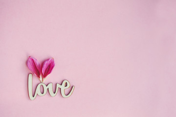lovely wooden handmade word love and two petals shaped as heart with copy space for your creativity