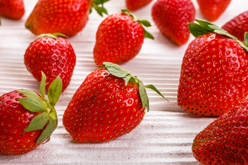 Juicy fresh strawberry on a rustic wooden background