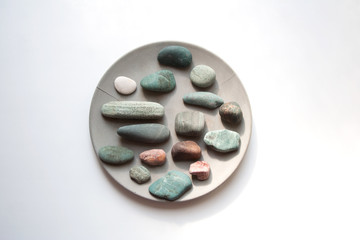 Obraz na płótnie Canvas Adriatic sea stones collection on grey concrete plate