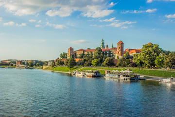 architecture and tourism for wallpaper concept of medieval beautiful castle near river in waterfront old city district in bright colorful day time on blue sky background