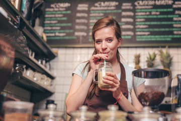 Young attractive girl drinking smoothie
