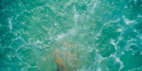 Splashes in the shallow water at the beach