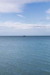 Fototapeta na wymiar Boat out on calm ocean