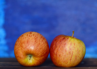 ripe apples on a striped blue background



