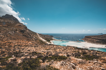View of the beautiful beach in Balos Lagoon, and Gramvousa island on Crete, Greece. Sunny day, blue Sky with clouds.