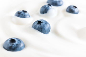 Organic yogurt and fresh berries blueberries, texture, background. Flat lay, top view, copy space 