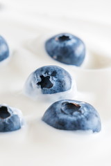 Organic yogurt and fresh berries blueberries, texture, background. Flat lay, top view, copy space 
