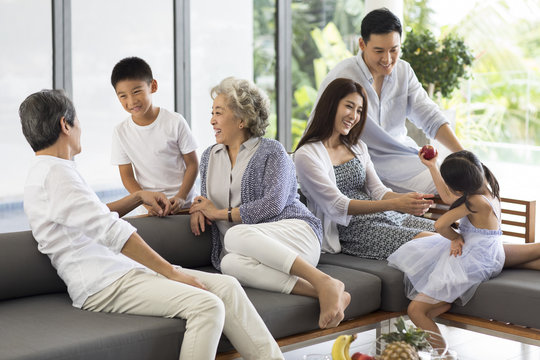 Happy Family Relaxing On Sofa At Home