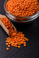 raw lentils on a dark stone background
