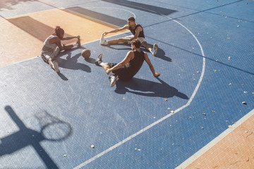 Basketball Players Stretching on the Court