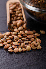raw lentils on a dark stone background