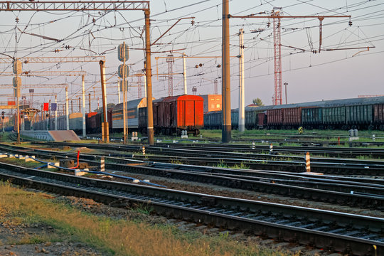 Сargo wagons parked at the railway freight station at a sunny summer evening