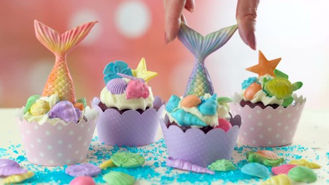 Mermaid theme cupcakes with colorful glitter tails, shells and sea creatures toppers for children's, teen's, novelty birthday and party celebrations.