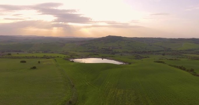 Aerial, beautiful landscape with hills and fields on sunset in Val d Orcia in Tuscany, Italy