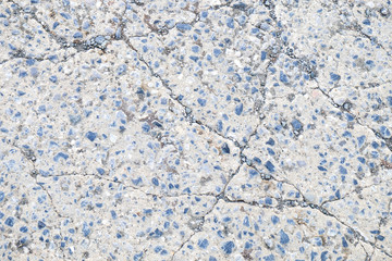 Cracked concrete with small rock textured background