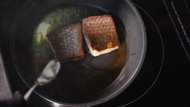 Pan-fried fish, Two pieces of loban fillet on the steaming frying pan.
