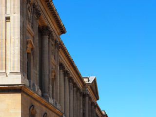 The Cour Carree is one of the main courtyards of the Louvre Palace in Paris.  Pavillon central (or pavillon Saint-Germain l'Auxerrois ), pavillon sud-est against the blue sky