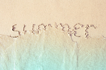 Summer written in the sea sand.
