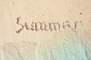 Summer written in the sea sand.