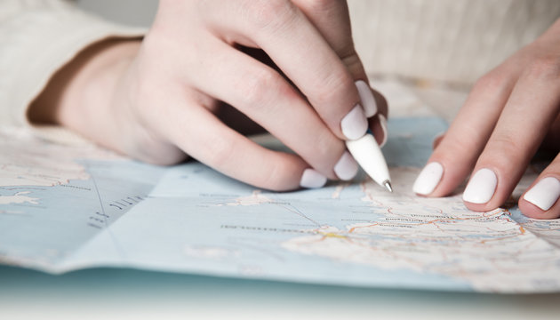 Female finger on map