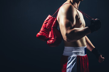 Red gloves hanging on the boxer's back.