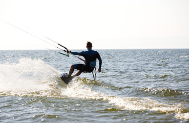 Kite surfing by the sea in sunny weather