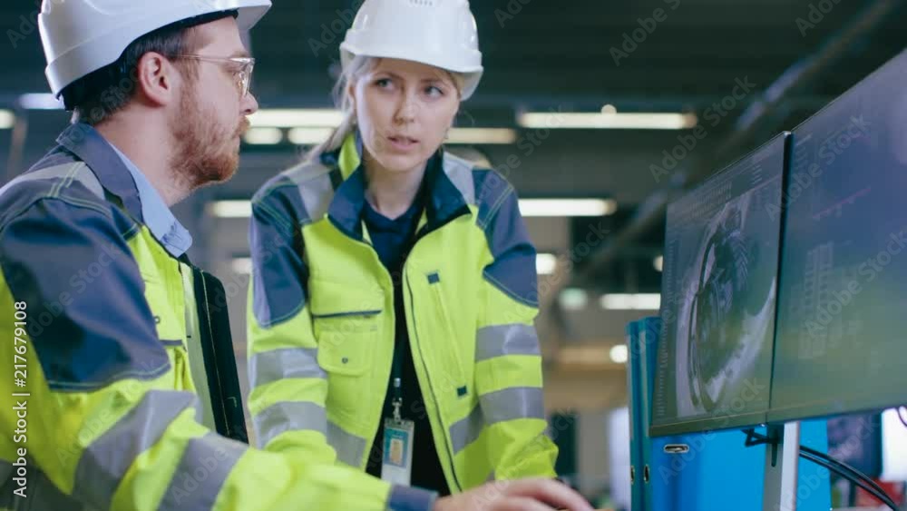 Poster inside factory male mechanical engineer and female chief engineer work together on the personal comp