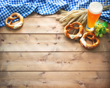 Oktoberfest background with Bavarian flag, beer glass and pretzel