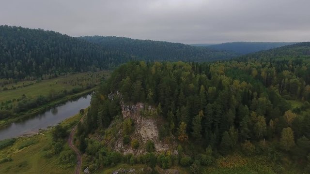 Flying over the beautiful autumn mountain River. Ural, Russia.