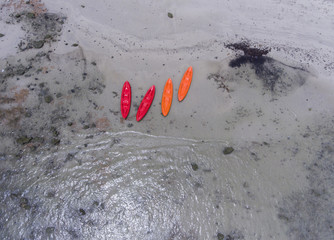 Kayaks on the beach shore.