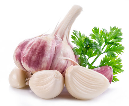 Garlic bulb, garlic cloves and parsley.