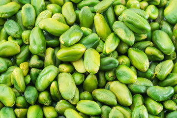 Lot of green pistachio nuts. Food background.