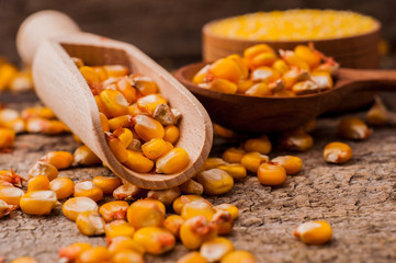 a bowl of corn is on a wooden table