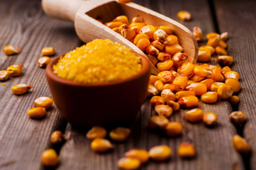 a bowl of corn is on a wooden table