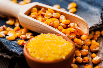 a bowl of corn is on a wooden table