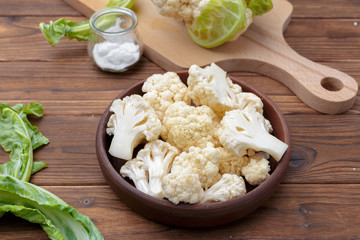 Organic cauliflower on wooden background