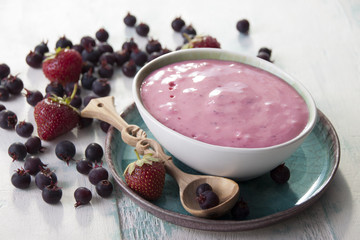 Smoothies of strawberries and irgi with yogurt in a ceramic bowl