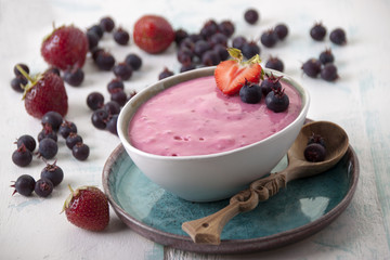 Smoothies of strawberries and irgi with yogurt in a ceramic bowl
