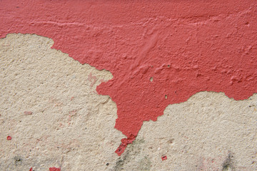 Red color painted on cement wall are peeling