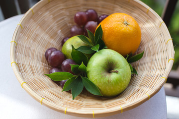 Bowl of fresh tropical fruit on the table. Horizontal
