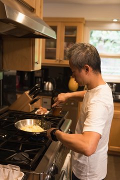 Father preparing food in kitchen