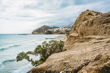 Fototapeta na wymiar Crete, Greece. beach with rocks and cliffs with view towards sea ovean on a sunny day.
