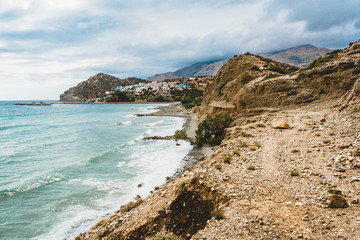 Fototapeta na wymiar Crete, Greece. beach with rocks and cliffs with view towards sea ovean on a sunny day.